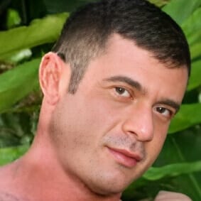 Luciano Prado pictured highlighting his above-average height in gay adult productions